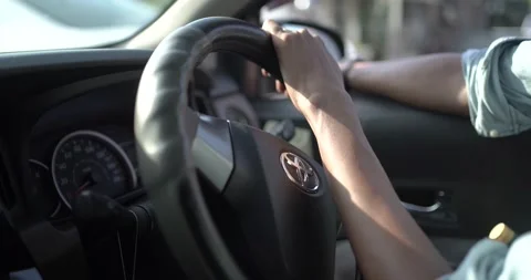 Close up of man hands driving a car during sunlight. driving with one hand Stock Footage 170435730