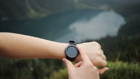Close up man hands gestures on a round screen modern smartwatch with a green Stock Footage 95450538