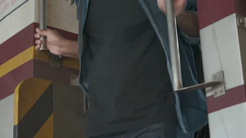 Close up man hands grabbing the train railing and stepping out of the train. 스톡 동영상 220874324
