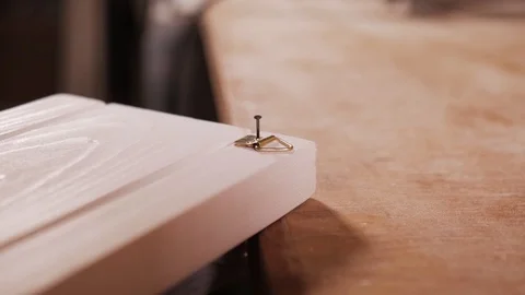 Close up. Man hands hammering a nail at the workshop. Handmade Stockbeeldmateriaal 110685430
