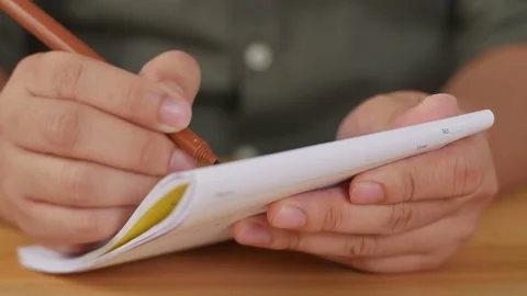 Close up of man hands holding and writing on notebook, clerk journalist or st Stock Footage 141593498