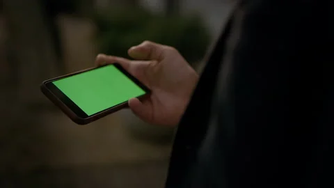 Close up man hands holding smartphone with green screen. Male professional Stock Footage 141253007