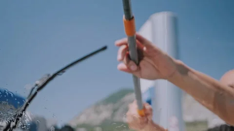 Close Up of Man Hands Holding Window Cleaning Squeegee Tool at Gas Station Stockbeeldmateriaal 338226727