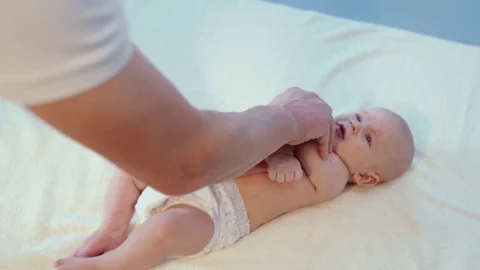 Close up to man hands make feet and sole massage to baby Video stock 121726110