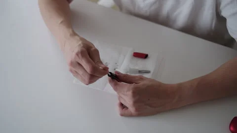 Close-up of man hands meticulously cleaning electronic cigarette vaporizer Stock Footage 318467252