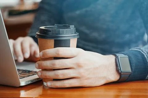 Close up of man hands with modern electronic watches and laptop in modern caf Stock Photos