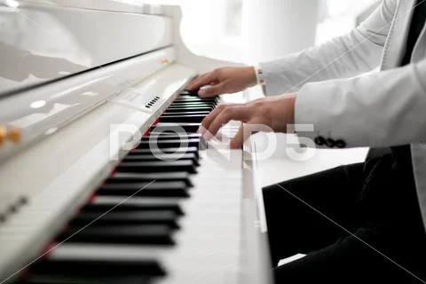 Close Up Of Man Hands Piano Playing. Male Pianist Hands On Grand Piano Keyboard
