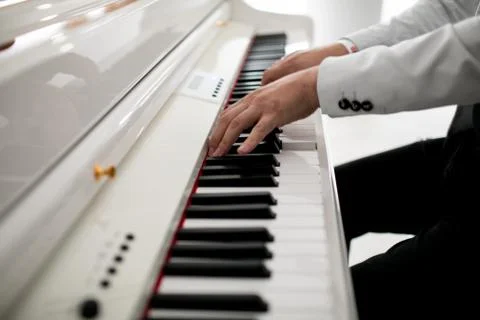 Close up of man hands piano playing. Male pianist hands on grand piano keyboard Stock Photos