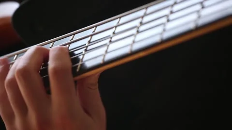 Close-up on Man hands playing on bass guitar. Stock Footage 68051909
