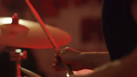 Close-up of a man hands playing on drums, red light drum, drummer drumstick Stock Footage 83000646