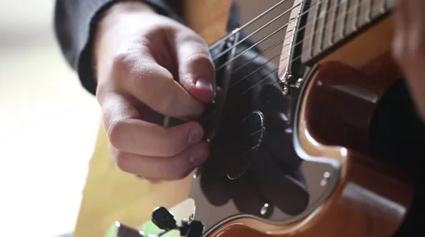 Close-up on Man hands playing on electric guitar. Stock Footage 68050820