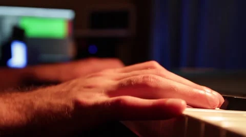 Close up of man hands playing on the piano and recording himself to the computer Stock Footage 66471746