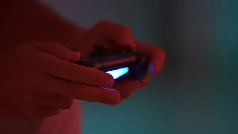 Close up the man hands playing on wireless gamepad. Tense playing in a video Stock Footage 243200295