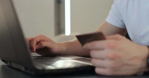 Close-up of man hands pressed the credit card code to pay online via the laptop Stock Footage 269148507
