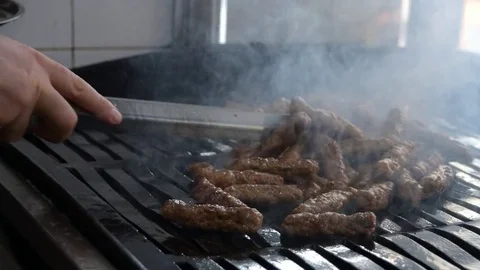 Close-up of Man hands puts lamb Kebabs into the plate Video stock 73519797
