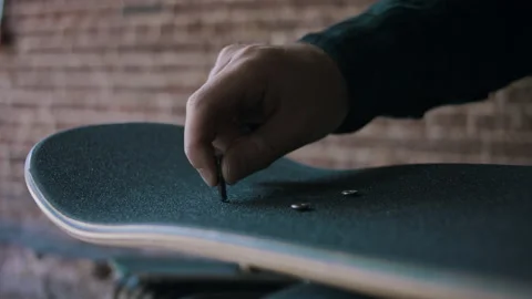 Close-up Of Man Hands Putting A Screw In His Skateboard Video stock 133625642