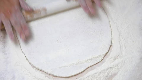 Close up to man hands with rolling pin preparing a piece of dough for cooking Stock Footage 305224048