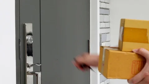 Close up man hands signing to get his package from delivery man Stock Footage 125975441