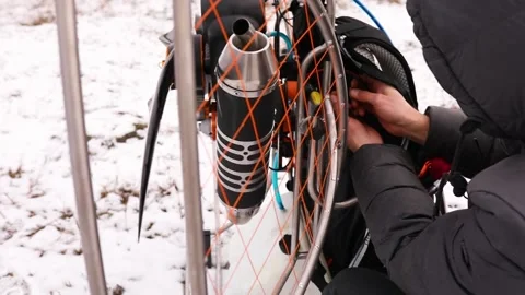 Close up of man hands starts to work a propeller, motor, engine of the paramotor Stock Footage 147497589
