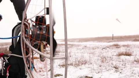 Close up of man hands starts to work a propeller, motor, engine of the paramotor Stock Footage 147497844