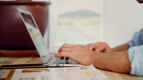 Close up of man hands typing laptop keyboard and using smartphone lying near at Stock Footage 114911298