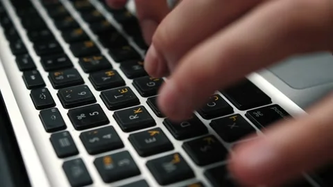 Close up man hands typing on laptop keyboard sitting at the table at home or Stock Footage 144067946