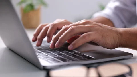 Close-up of man hands typing on laptop keyboard on white table at home Stock-Footage 161614863