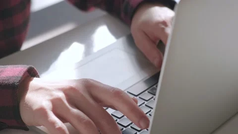 Close up of man hands typing on laptop while working in cafe Stock Footage 236631727