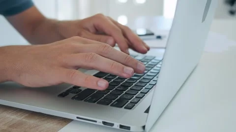 Close up of man hands typing on laptop computer keyboard and surfing internet on Stock Footage 270005068