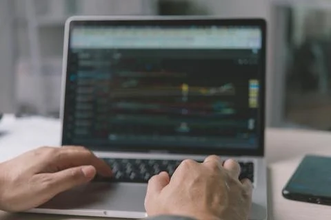 Close up man hands typing on laptop keyboard, analyzing stock market tradin.. Stock Photos