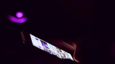Close up of man hands typing scrolling pictures phone at night. Stock Footage 91083213