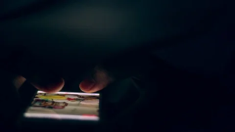 Close up of man hands typing scrolling pictures phone at night. Stock Footage 91083248