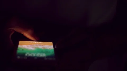 Close up of man hands typing scrolling pictures phone at night. Stock Footage 91384231