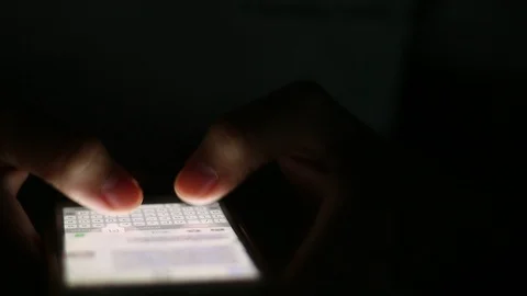 Close up of man hands typing scrolling pictures phone at night. Stock Footage 93948710