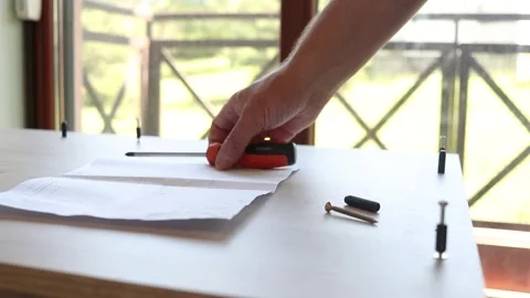 Close up of man hands unfolding instruction manual and preparing screwdriver Stock Footage 346381816