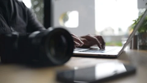 Close-up of a Man Hands use Laptop and Sony Camera at Cafe Table Stock Footage 95636465