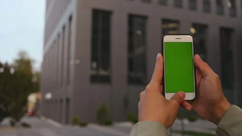 Close up man hands use smartphone on business office background green screen Stock Footage 117433137