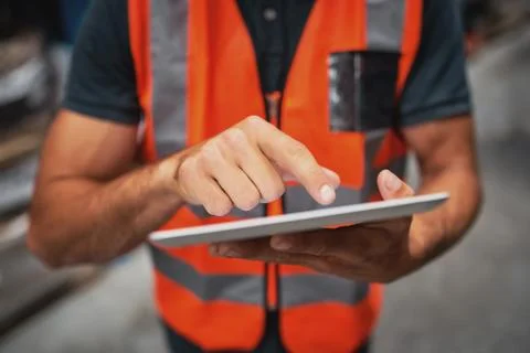 Close-up of man hands using digital tablet computer while standing in the Stock Photos