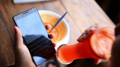 Close up of man hands using smart phone at the bar, drinking cocktail and Stock Footage 44050261