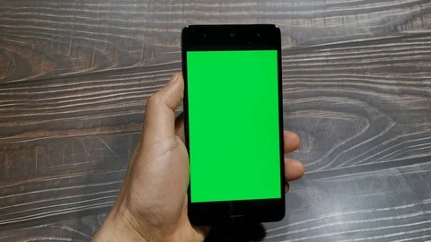 Close-up of man hands using smartphone with green screen. Stock Footage 128829105