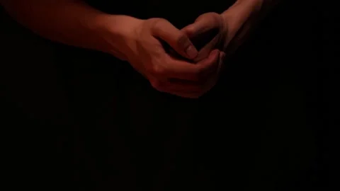 Close up man hands waiting on dark background. Guy is considering 動画素材 142138949