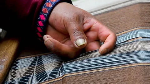 Close up of a man hands weaving on a loom as his ancestors used to do Stock Footage 100078350
