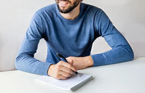Close up man hands writing down goals for the new year 2021. Write a wish list Stock Photos