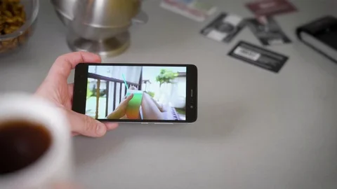 Close-up Of Man Having Video. In the evening in the kitchen, a man watches a Stock Footage 81810502