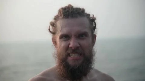 A close-up of the man he looks into the camera and breathes angrily. Video stock 234020142