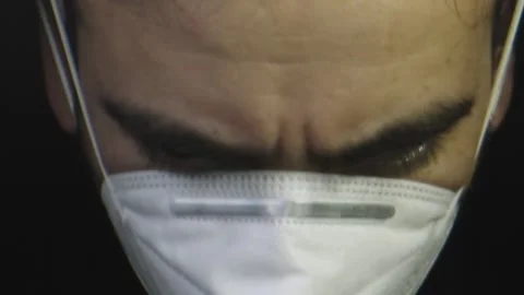 Close-up of man as he puts his protective face mask on Stock Footage 132217406
