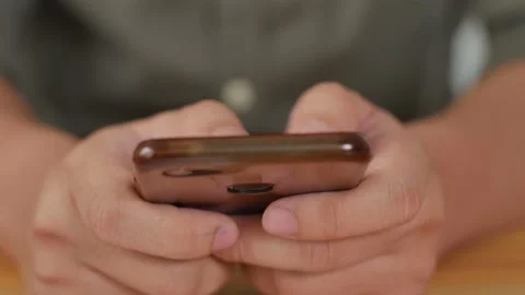 Close up of man holding and using smart mobile phone, scrolling browsing inte Stock Footage 141567852