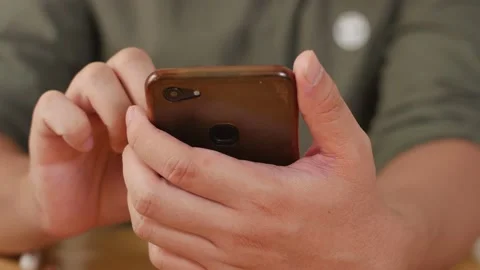 Close up of man holding and using smart mobile phone, scrolling browsing inte Video stock 141614004