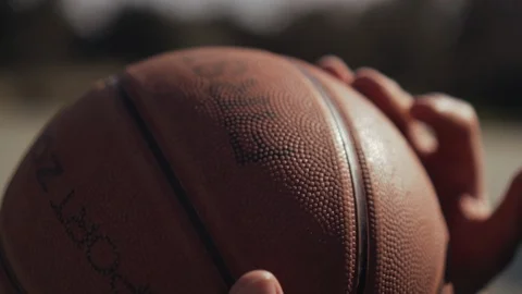 Close-up of man holding a basket ball, preparing for a dribble or a shot. Stock Footage