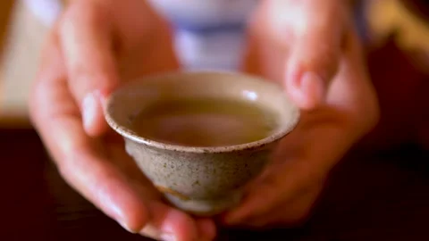 Close up a man holding a cup of chinese tea. Stock Footage 140714582